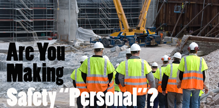 Group of construction workers wearing white hard hats and high-visibility safety vests walking toward a large industrial crane with bold overlay text reading “Are You Making Safety ‘Personal’?”