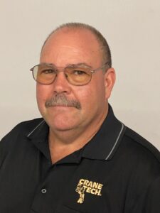 Professional headshot of Crane Tech instructor Dan Calabro wearing a Crane Tech polo shirt.