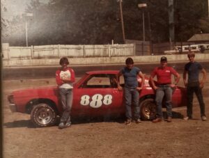 Dan Calabro (far right) with fellow racers and the family's stock car during his early racing years.