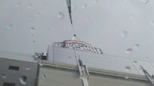 The iconic Block O sign being lifted into place at Ohio Stadium during a crane operation Wayne Essman helped complete.